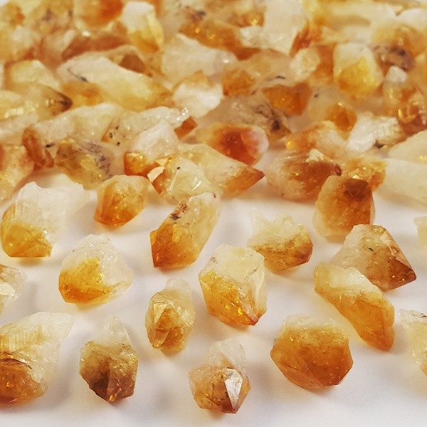 Pile of Citrine Teeth (mini) - lots of small orange points - on a white background