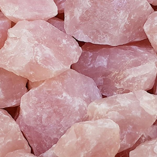 Close up of Rough Rose Quartz - rough chunks of soft pink rocks