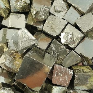 Close up on Pyrite Cubes - solid, metallic cubes of pale gold and silver- in a pile