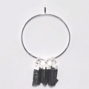 One Black Tourmaline Ring Pendant - three black shards suspended from a silver hoop - on a white background