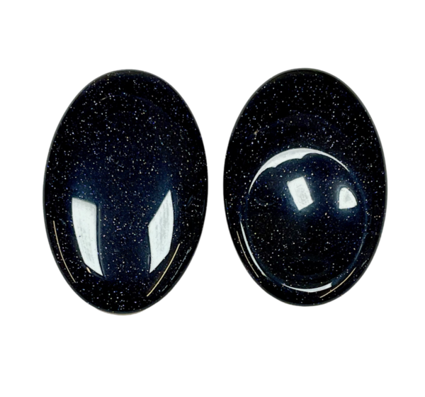 Two Blue Goldstone Thumb Stones - blue with copper flecks - on a white background