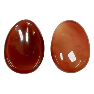 Two Carnelian Worry Stones - red and orange - on a white background