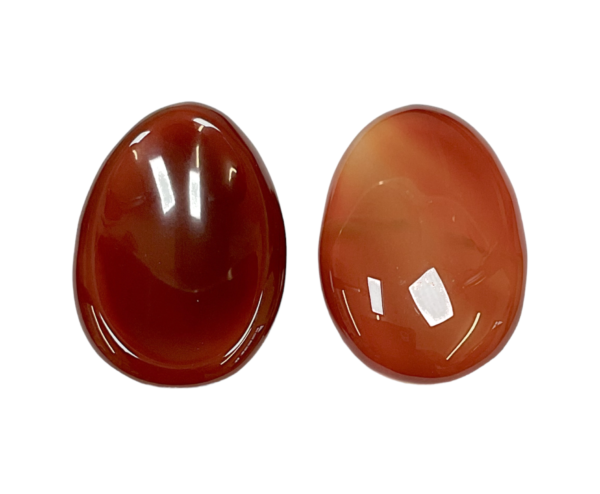Two Carnelian Worry Stones - red and orange - on a white background