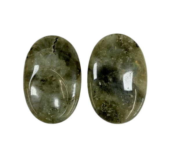 Two Labradorite Thumb Stones - green with areas of rainbow - on a white background