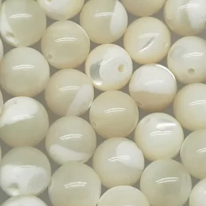 Close up of Mother of Pearl Round Beads - cream and white coloured spheres.