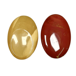 Two Mookaite Thumb Stones - red and yellow - on a white background