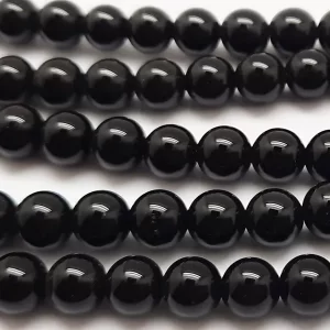 Close up of Black Agate Round Beads - black coloured spheres.