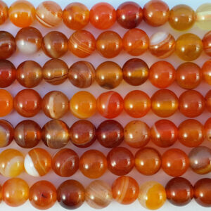 Close up of Carnelian Round Beads - red and yellow coloured spheres.