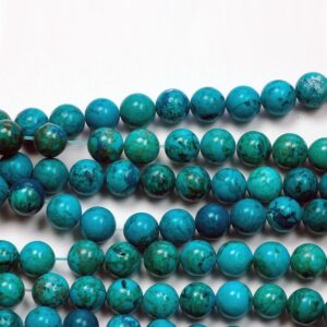 Close up of Turquoise Round Beads -teal with green and black veining coloured spheres.