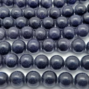 Close up of Blue Goldstone Round Beads - dark blue with copper flecks coloured spheres.