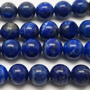 Close up of Lapis Lazuli Round Beads - dark blue with grey and gold banding coloured spheres.