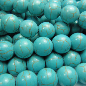 Close up of Turquoise Round Beads -teal with green and black veining coloured spheres.