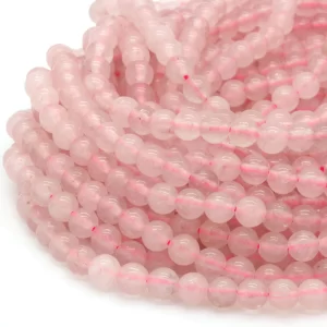 Close up of Rose Quartz Round Beads - pale pink coloured spheres.