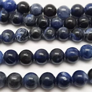 Close up of Sodalite Round Beads - dark blue with grey banding coloured spheres.