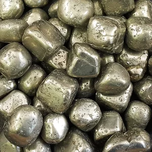 Close up of Pyrite tumble stones - golden metallic cubes