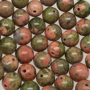 Close up of Unakite Round Beads - green and terracotta coloured spheres.