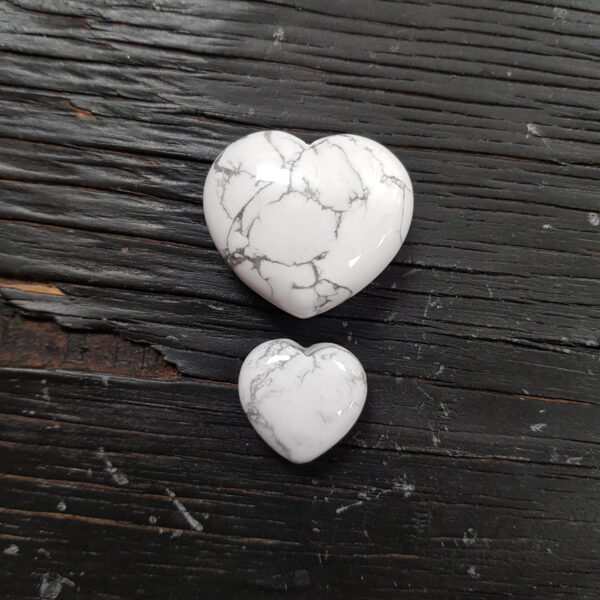 Howlite Hearts - white with grey veins in 2 descending sizes, on a black wooden board
