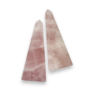 Two Rose Quartz Obelisks - four sided tall point in pink stone with some inclusions - on a white background