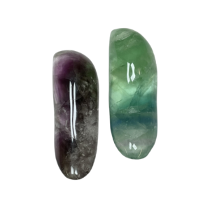 Two Fluorite Tongue Massagers - translucent purple and green - on a white background