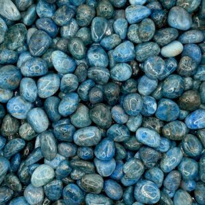 Close up of Blue Apatite tumble stone (pile of deep blue stone) in a pile