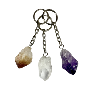 Three Natural Point Keychains - Citrine, Amethyst, Quartz - on a silver metal chain and keyring, in a fan formation with a white background.