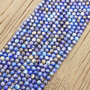 Close up of Lapis Lazuli Faceted 4mm beads - rows of small angular blue with gold flash beads on a dark wooden board
