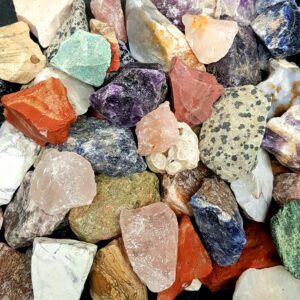 Close up of Rough Tumbling Mix - assortment of different coloured stones (pink, green, blue, red, yellow)