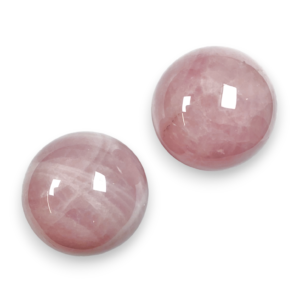 Two Rose Quartz spheres - pink stone - on a white background