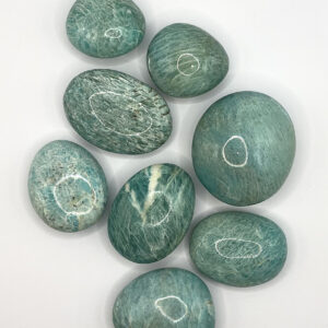 Group of Amazonite Pebbles (pale blue with white striations and veining) on a white background