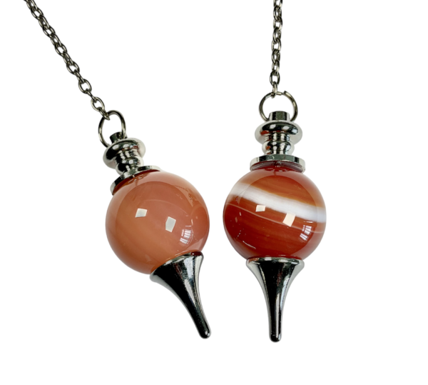 Example of two Carnelian Ball Pendulums - 20mm orange and red sphere in a silver holder - on a silver chain, on a white background