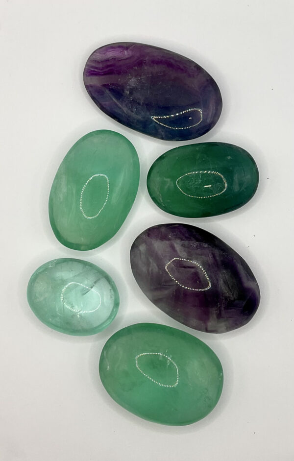 Group of Fluorite Pebbles (translucent green or purple) on a white background