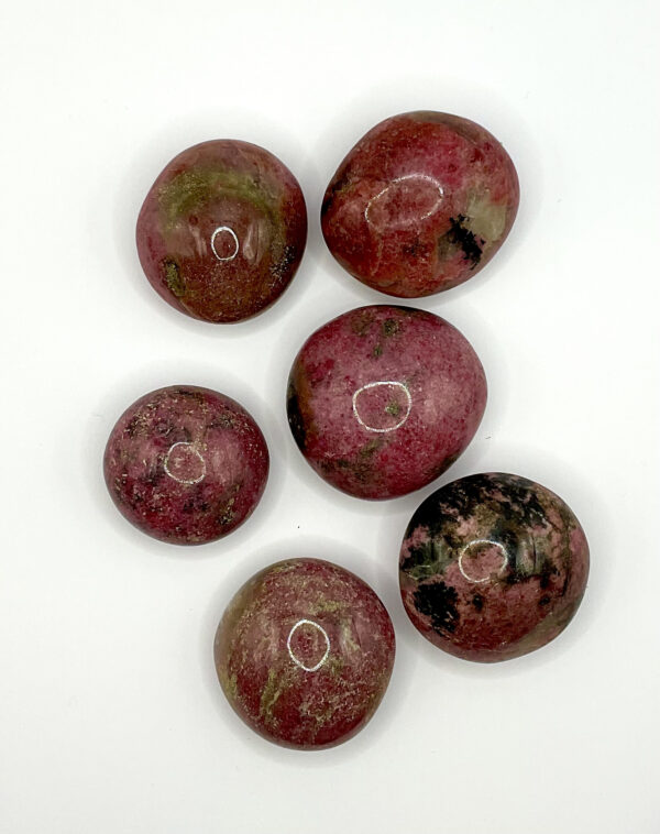 Group of Rhodonite Pebbles (dark pink with areas of black and quartz) on a white background