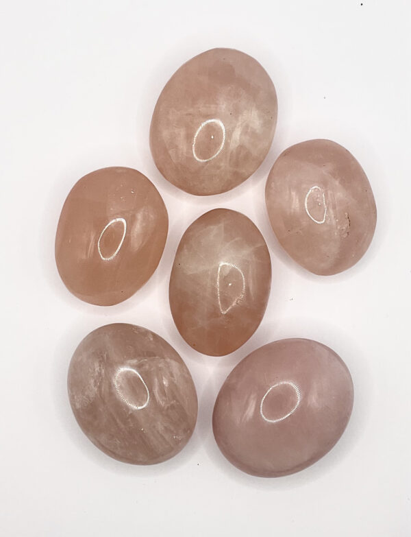 Group of Rose Quartz Pebbles (pink and pale pink stones) on a white background