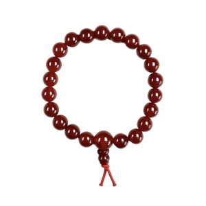 One Red Agate power bracelet viewed from the top - red round beads with one larger bead - on a white background