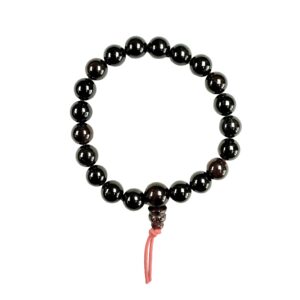 One Garnet power bracelet viewed from the top - dark red round beads with one larger bead - on a white background