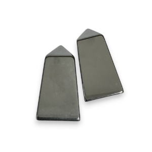 Two obelisks - grey metallic with a highly polished finish Haematine - on a white background