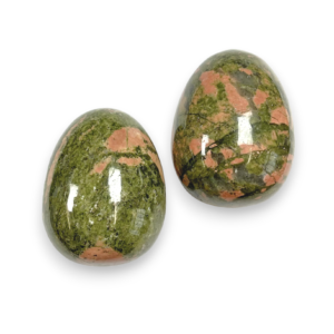 Two Unakite eggs - green stone with pink mossy blooms - on a white background