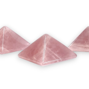 Three rose quartz pyramids - pale pink - on a white background