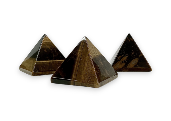 Three Tigers Eye pyramids - black, brown and gold banding - on a white background