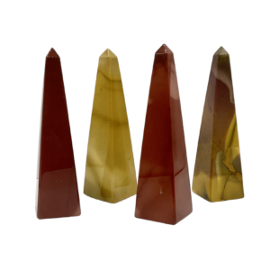 Four obelisks in a row - alternating red and yellow Mookaite - on a white background