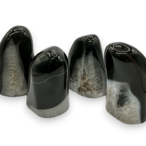 Group of domed freeforms - jet black with areas of crackled white/transparent quartz - on a white background