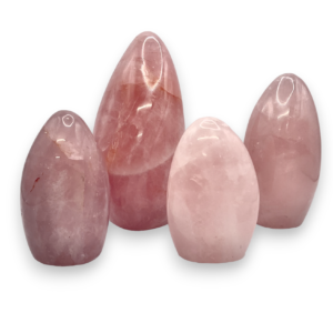 Group of domed freeforms - pale pink with some white banding rose quartz - on a white background