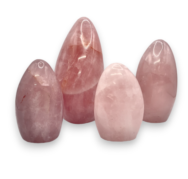 Group of domed freeforms - pale pink with some white banding rose quartz - on a white background