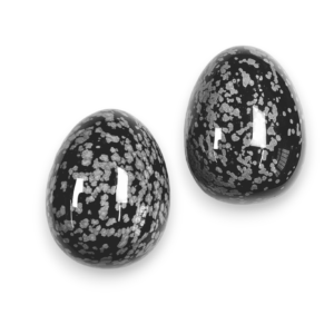 Two Snowflake Obsidian eggs - black stone with grey blooms and flowers - on a white background