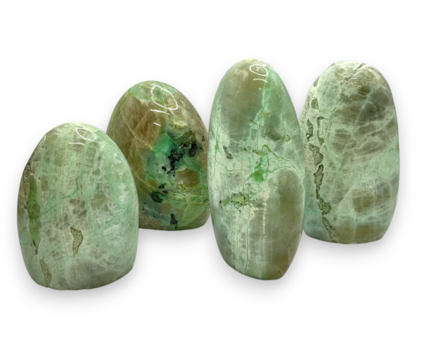 Group of domed freeforms - mint green with areas of pale brown and green garnierite - on a white background