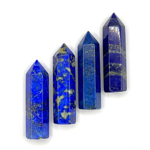 Four polished points in a descending line - blue and gold lapis lazuli - on a white background