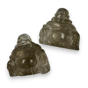 Two buddhas - clear stone with hues of black and grey throughout smoky quartz - on a white background