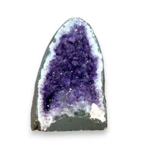 Amethyst Cave (1) shown from the front - half of a giant geode with purple points - on a white background
