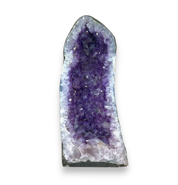 Amethyst Cave (2) shown from the front - half of a giant geode with purple points - on a white background