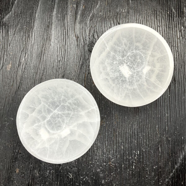 Two Round Bowl (Small) - Selenite from above - slightly translucent white bowls - on a dark wooden board